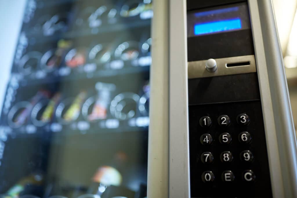 sell, technology and consumption concept - vending machine keyboard on operation panel